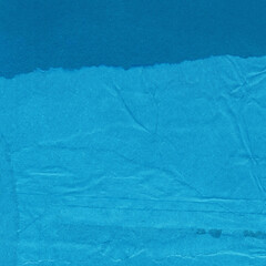 Blue torn paper collage close-up. Texture made from various paper and cardboard parts. Damaged old paper background. Vintage blank wallpaper. Material design backdrop.