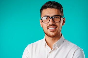 Portrait of a young mixed race businessman against blue background