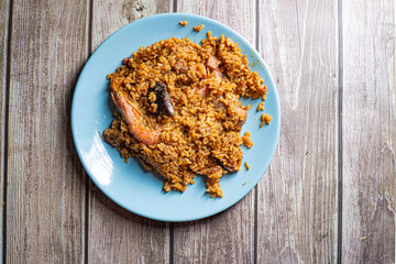 Spanish paella rice with seafood served on a blue plate