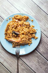 Spanish paella rice with seafood served on a blue plate
