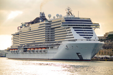 Mega modern MSC cruiseship or cruise ship liner in port of Valletta, Malta island with panoramic...