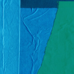 Blue torn paper collage close-up. Texture made from various paper and cardboard parts. Damaged old...