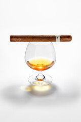 NO LOGOS OR TRADEMARKS!  SELF MADE LABELS! Close up view of glass of whiskey with cigar on top on white back