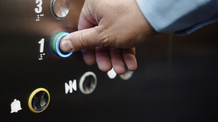 Male hand pressing the elevator button