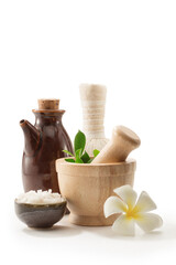 close up view of mortar, salt, oil and Herbal Compress on white back. 