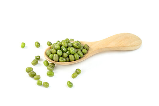 green mung beans with wooden spoon isolated on white background