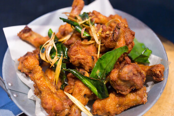 Deep fried chicken with Thai herbs. It’s marinated with sauce and Thai herbs (garlic, pepper) ,then deep fried it until golden and herbs (lemon grass, bergamot leave) crispy.