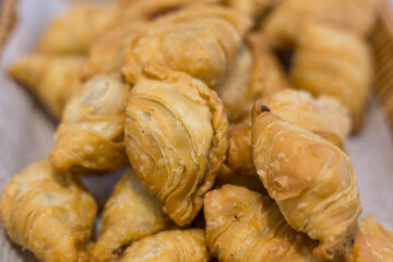 Curry puffs are a snack of Central in Thailand. It is a small pie that contains chicken and potatoes in a deep fried pastry shell.