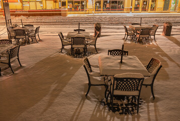 Patio dining tables with winter snow in Canmore, Alberta, Canada