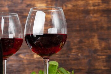 Two wine glasses against dark wooden background