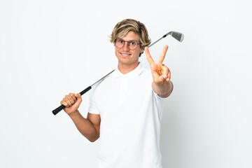 English man playing golf smiling and showing victory sign