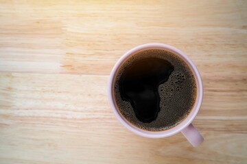 coffee top view. coffee pink cup on wood background. morning time winter concept.