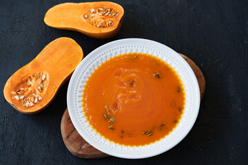 Homemade pumpkin soup on a black table