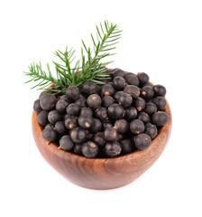 Dry juniper berries in wooden bowl, isolated on white background. Common Juniper fruits.
