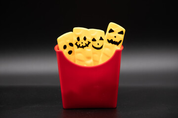 halloween background. food party. fries with faces. funny halloween party, movie concept. dark background