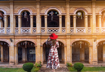 Thai female tourists gaze at ancient architecture French style village in Tharae Sakon Nakhon...