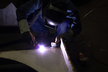 Metal workers use manual labor, Skilled welder, Factory workers making OT. Welder is welding the steel in the factory.