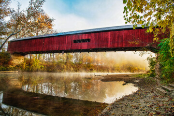 Cox Ford Covered Bridge in Rural Indiana. This is a working bridge on a public road. The picture was taken in the early morning with fog on the creek.