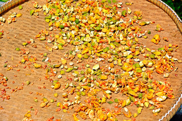 Bitter Cucumber (Momordica charantia  L.) drying in the sun laying on the bamboo basket.