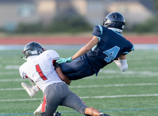 Amazing athletes making great catches and runs during a competitive football game