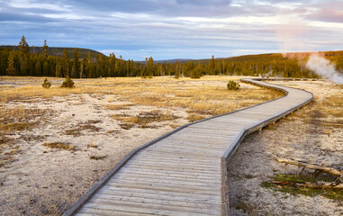 Wooden bridge in Yellowstone National Park at sunset, Wyoming, USA.