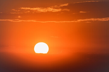 Dramatic sunset sky with dark clouds and red sun