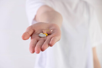 outstretched palm with different pills