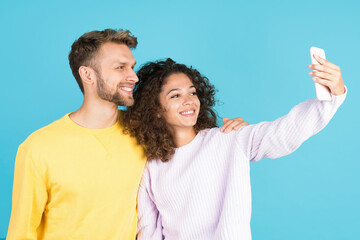 Two mixed race people on blue background