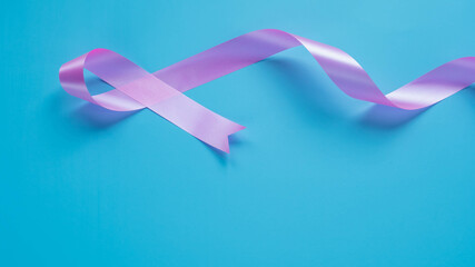 Obraz na płótnie Canvas Pink ribbons on sky blue background , Breast cancer awareness, abdominal cancer awareness , world cancer day