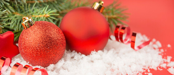 Christmas red balls on a red background. Festive Christmas decorations. Christmas background. Banner. Copy space.