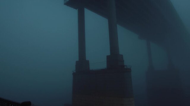 Bridge in the fog. The river hides a large bridge in the fog. The video can be used in movies, reportage, as footage, in a music video.