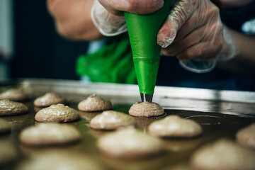 onfectioner making macaroons in pastry shop