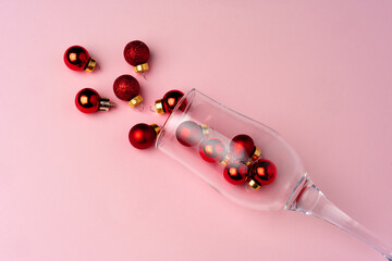 Champagne glass with small Christmas baubles scattered