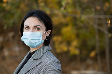 Beautiful caucasian woman with disposable face mask. Protection versus viruses and infection....