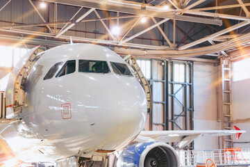 Airplane in the hangar, view of the nose of the cockpit.