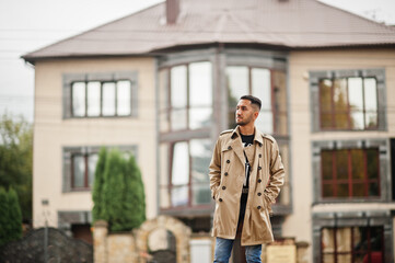Stylish kuwaiti man at trench coat.