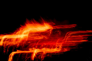 Fototapeta na wymiar Fire sparks create imaginative yellow orange light trail pattern on black, creative effects for backgrounds