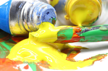 close-up colorful paint splashes with brush background