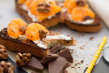 Delicious toast with sweet tangerine on black wood background