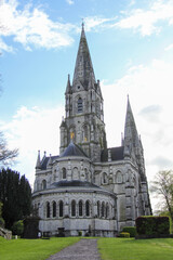 Fototapeta premium Stone cathedral finished with spikes and vegetation around the Irish village of Blarney
