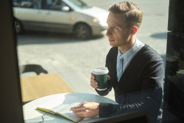 Handsome busyness man coffee time at sunny day in office district