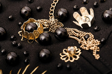 Embroidery composition of golden flowers and black beads on fabric