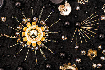 Golden metal flower with crystal beads around on fabric