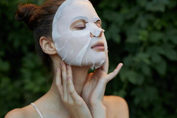Beautiful woman white mask Copy Space pure leather cosmetology bushes in the background
