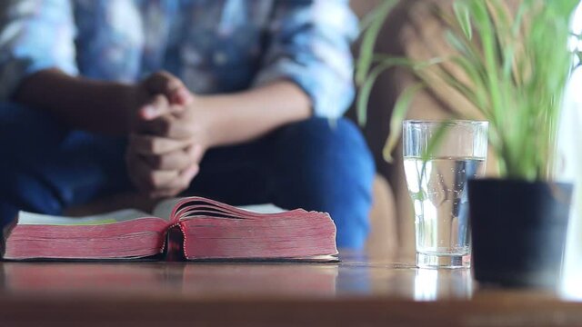 Close up the bible with a boy praying in morning at home, Online church in home, Home church during quarantine coronavirus Covid-19, Religion concept.