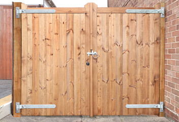 Double wooden gates with metal latch and hinges