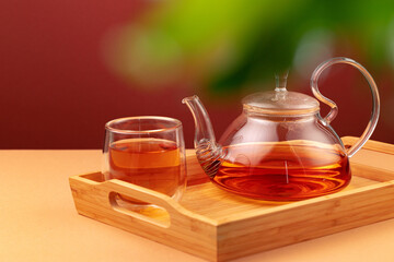 Glass teapot and cup with black tea