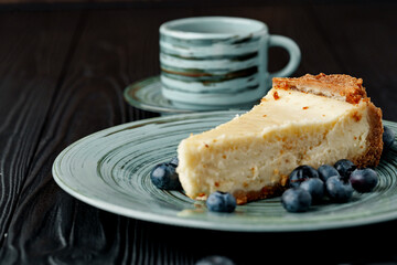 Piece of classic cheesecake on green plate