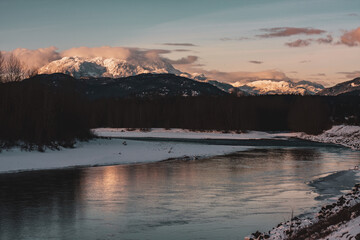 Distant snowy epic mountain near lake with nesting bald eagles.