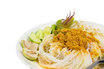 Rice noodles in fish curry sauce with vegetables in white plate on white background